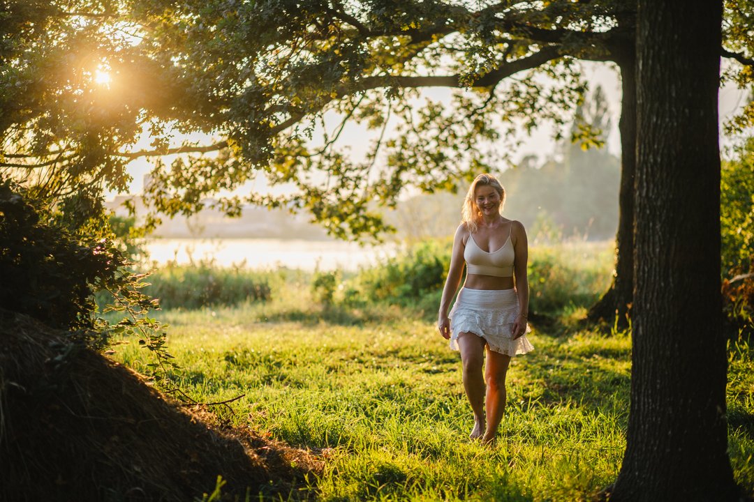Katie Stuka in the sunlit greenery